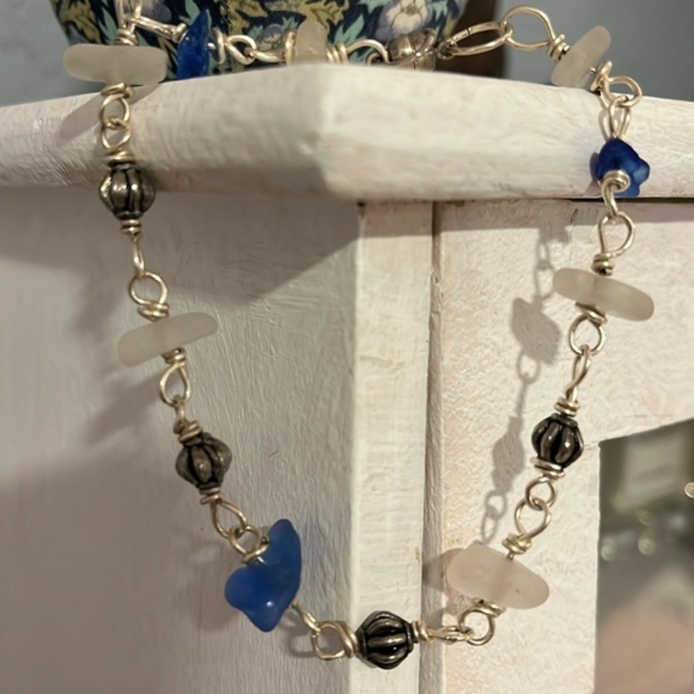 Pretty silver & sea glass bracelet. 9 real glass pieces on silver. Easy clasp